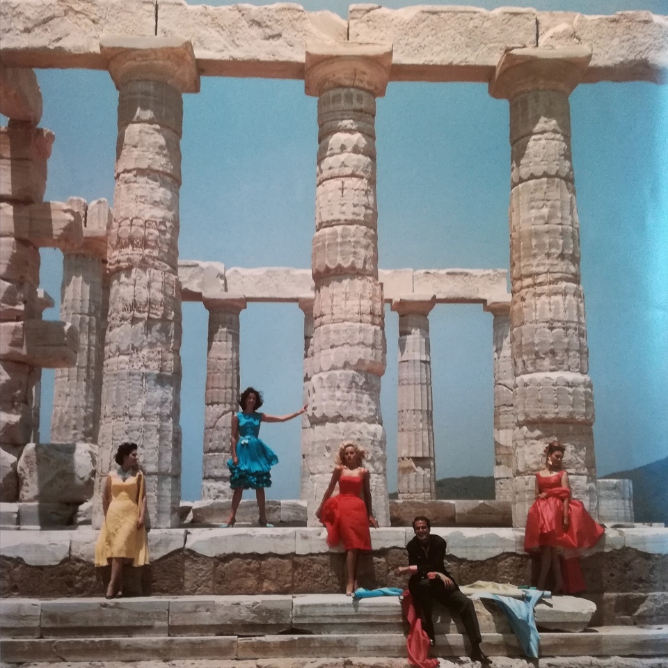 Slim Aarons. Greek fashion designer Dimitris Kristas poses with four models against a backdrop of the ancient Doric temple to POseidon at Sounion, 1967