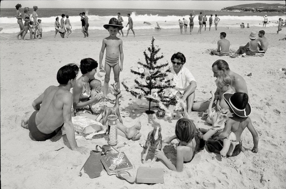 Max Scheler. Australia near Sydney 1959. German immigrant family Hufnagel with presents and nylon tree at the beach